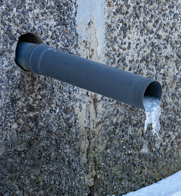 A Water Pipe In A House With A Frozen Piece Of Ice. Rainwater Ha